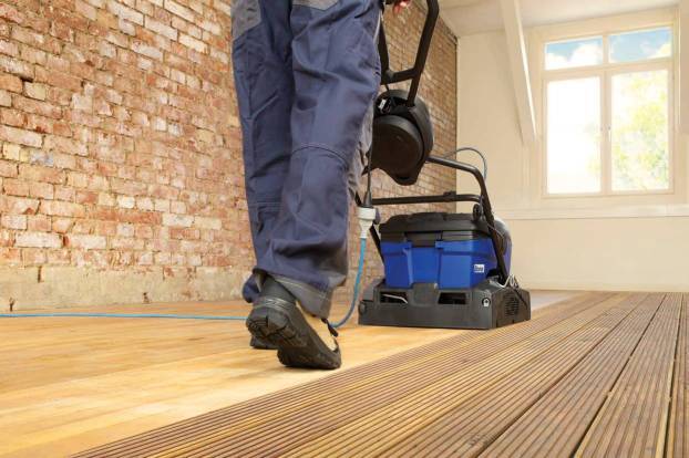 Pro using a Power Scrubber to clean floor