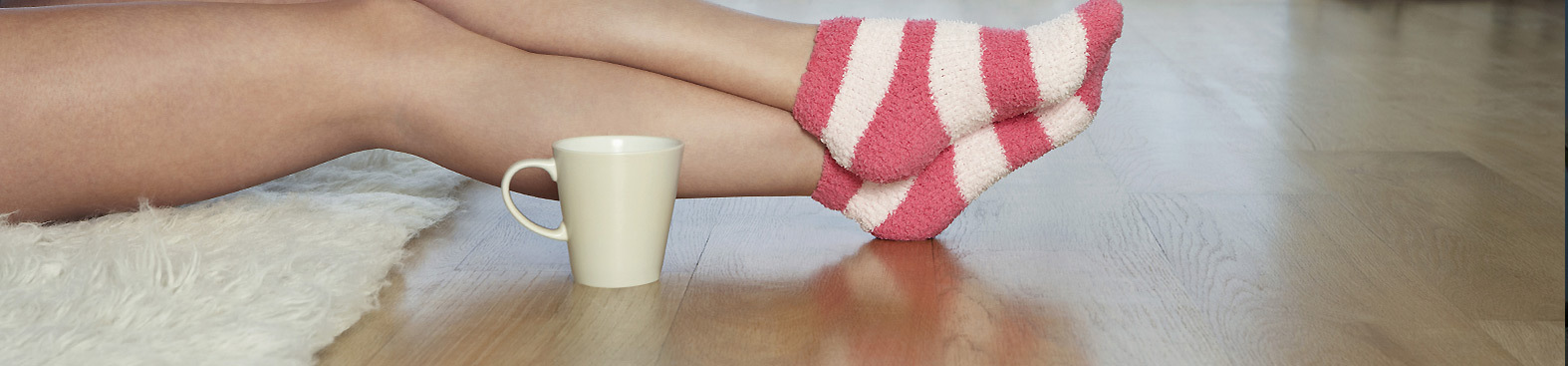 Feet in socks hardwood floor